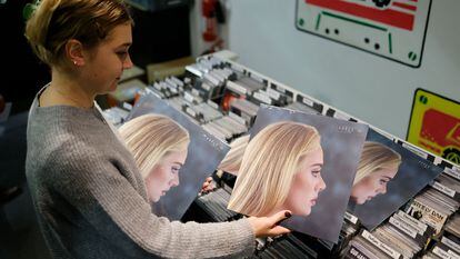 A London clerk in a Soho record shop with Adele's album '30'.