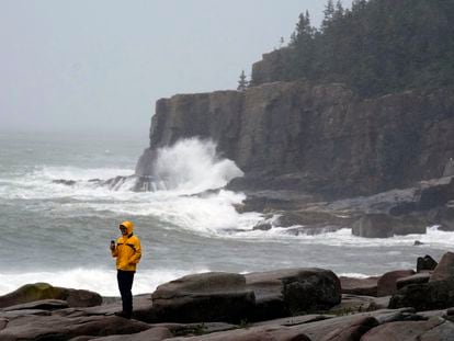 Chris Crawford, of Mount Desert Island, Maine, films the raging surf near Otter Point in Acadia National Park.