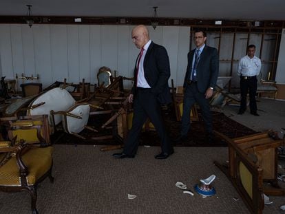 Judge Alexandre de Moraes walks among the destruction caused by the coup plotters in the Supreme Court building, January 11, 2023.