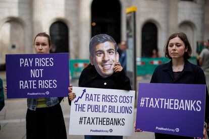 An activist wearing a British Prime Minister Rishi Sunak mask protests against rising interest rates outside the Bank of England in London on Thursday.