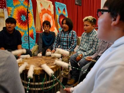 Students from Rosebud Elementary School perform in a drum circle during a meeting about abusive conditions at Native American boarding schools at Sinte Gleska University on the Rosebud Sioux Reservation in Mission, S.D., Saturday, Oct. 15, 2022.