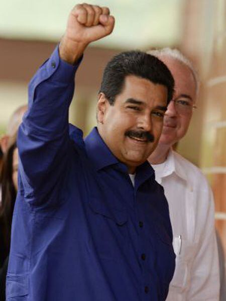 Venezuela's President Nicolás Maduro (l) gestures as he arrives for the opening of the Petrocaribe Summit, in Caracas on May 5.