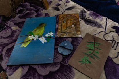 Some of the drawings of young refugee Rahif Almeari on the pieces of wood that his father prepares.  In addition to Palestinian symbols, the teen also paints nature scenes and landscapes.