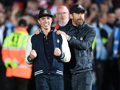 US actor and Wrexham owner Rob McElhenney (L) and US actor and Wrexham owner Ryan Reynolds (R) celebrate on the pitch after the English National League football match between Wrexham and Boreham on April 22, 2023.