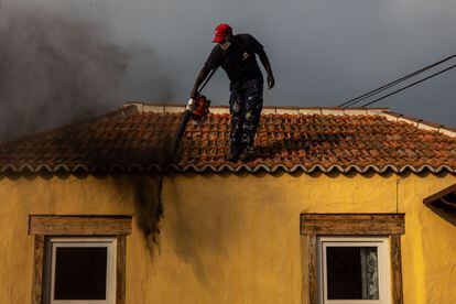 Federico's colleague Moduo clears the ash from a house in El Paso.