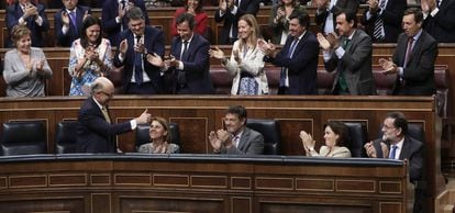 Deputies with Spain's ruling Popular Party applaud following the budget vote.