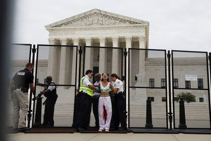 An abortion rights  activist is arrested outside the US Supreme Court.