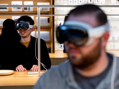Customers try on the Apple Vision Pro at an Apple store in The Grove, Los Angeles, during the launch on February 2, 2024.
