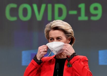 EU Commission President Ursula von der Leyen removes her protective mask at the start of a news conference about a common EU Covid-19 vaccination certificate in Brussels.