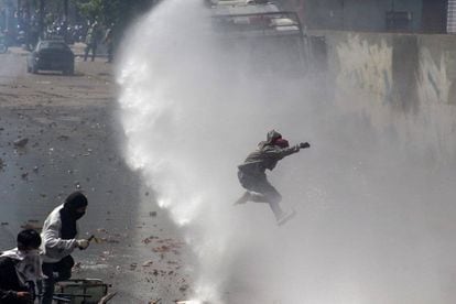 Riot police disperse protesters in April using water cannon.