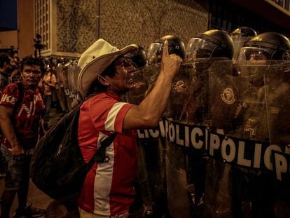 A protester faces riot police in a march against Dina Boluarte in Lima (Peru), in February 2023.