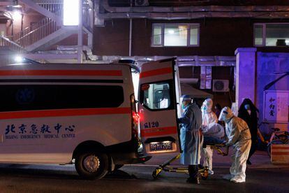 In Beijing, medical personnel put a patient inside an ambulance, on Friday, November 9, 2022.