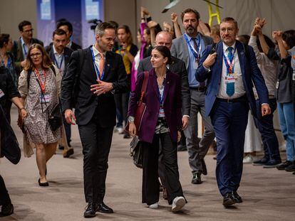 Kai Mykkanen (L), Finland's Minister of the Environment and Climate Change, and Sweden's Minister for Climate Romina Pourmokhtari (R) arrive for continuing negotiations during the COP28 in Dubai, December 11, 2023.