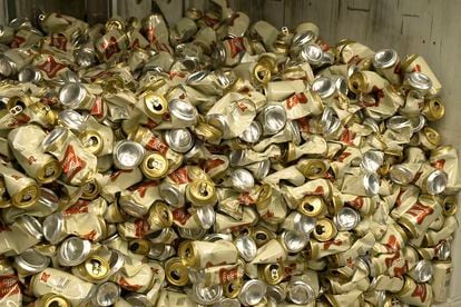 Cans of Miller High Life beer sit in a container after being crushed at the Westlandia plant in Ypres, Belgium, Monday, April 17, 2022