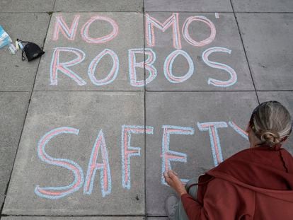 Martha Hubert writes a message opposing a proposed robotaxi expansion on Thursday, Aug. 10, 2023, in San Francisco