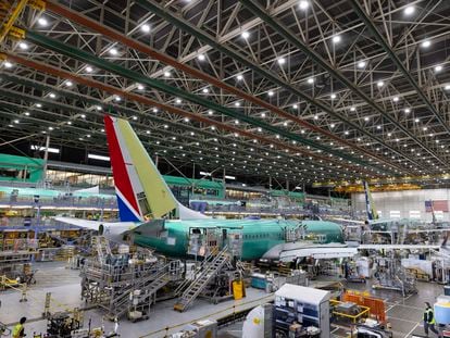 FBoeing employees work on the 737 MAX at Boeing's Renton plant in June 2022.
