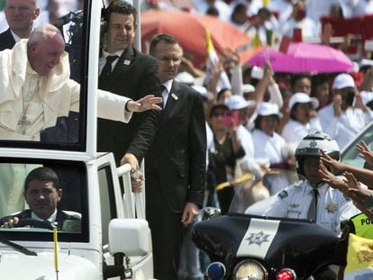 The pope waves to a crowd in Ecatepec on Sunday.