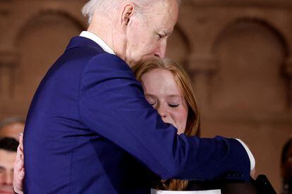U.S. President Joe Biden embraces Jackie Hegarty, a Sandy Hook school shooting survivor during the 10th Annual National Vigil for All Victims of Gun Violence in Washington, U.S. December 7, 2022.