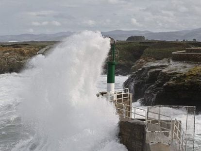 A wave crashes into a lighthouse on the Galician coast this week. 