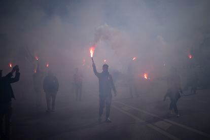 Protesters march with flares during a demonstration in Marseille, southern France