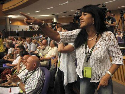A woman shouts at Bankia Chairman Jos&eacute; Ignacio Goirigolzarri as he delivers a speech during the annual shareholder meeting. 