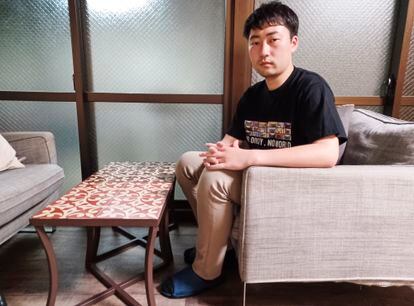 Rikuto Fukuda, 25, in a common room within the flatshare where he lives, in Kyoto, Japan.