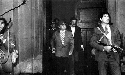 President Salvador Allende (center), flanked by bodyguards, in the Palacio de la Moneda on the day of the coup in Chile.