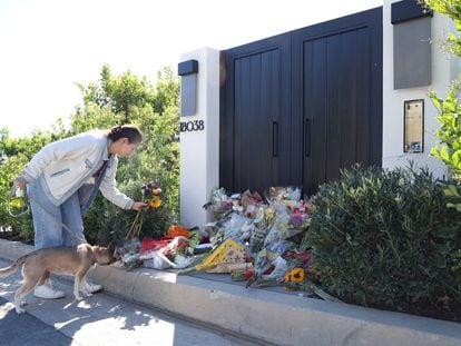 A person leaves flowers outside the home of late actor Matthew Perry in Pacific Palisades, California, U.S., October 31, 2023.