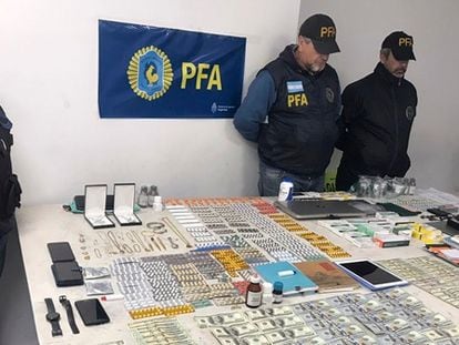 Police display money and other objects seized during the raid in Buenos Aires.