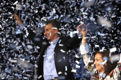 Outgoing Buenos Aires Mayor Mauricio Macri, left, holds hands with running mate Gabriela Michetti.
