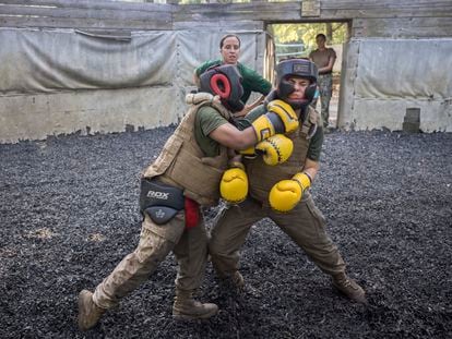 U.S. Marine Corps martial arts instructor Sgt. Micah Shull, center, trains two female recruits during a hand-to-hand combat drill during a portion of training known as the Crucible at the Marine Corps Recruit Depot, Thursday, June 29, 2023, in Parris Island, S.C.