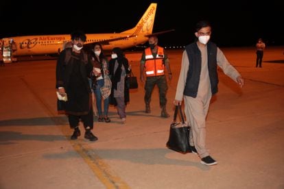 A group of Afghan evacuees arrives at the Torrejón de Ardoz air base in Madrid.