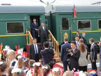In this photo provided by the North Korean government, North Korean leader Kim Jong Un, center, steps down from his train after arriving in Artyom, near Vladivostok, Russian Far East on Saturday, Sept. 16, 2023.