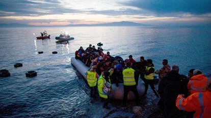 Refugees arrive in an inflatable boat from Turkey on the Greek island of Lesbos near the port city of Mitilini.