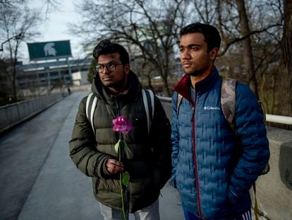 Michigan State international students Dheeraj Thota, left, and Chirag Bhansari, both freshman studying computer science, found a single rose on their walk to class as campus opens back up for the first day of classes on Monday, Feb. 20, 2023 at Michigan State University in East Lansing, Mich.