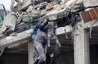 Residents retrieve an injured girl from the rubble of a collapsed building following an earthquake in the town of Jandaris, in the countryside of Syria's northwestern city of Afrin in the rebel-held part of Aleppo province, on February 6, 2023. 