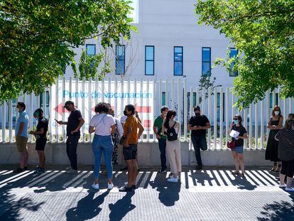 People wait in line to be vaccinated outside Isabel Zendal Hospital in Madrid.