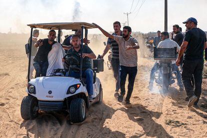 A captured Israeli civilian is taken to Gaza in a golf cart by Palestinian militants.