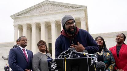 Evan Milligan, center, plaintiff in Merrill v. Milligan, an Alabama redistricting case, speaks with members of the press following oral arguments outside the Supreme Court in Washington, in October 2022.