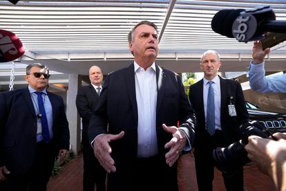 Former Brazilian President Jair Bolsonaro speaks to the press outside his home after Federal Police agents carried out a search and seizure warrant in Brasilia, Brazil