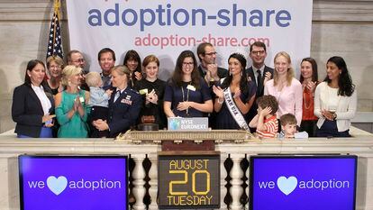 Adoption-Share founder and CEO Thea Ramirez, center, and fellow adoption supporters ring the opening bell at the New York Stock Exchange in New York on Aug. 20, 2013.