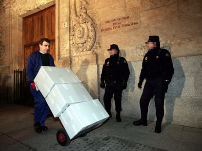 An officer moves boxes containing the so called Salamanca Papers on January 19, 2006 under the watchful eye of police.