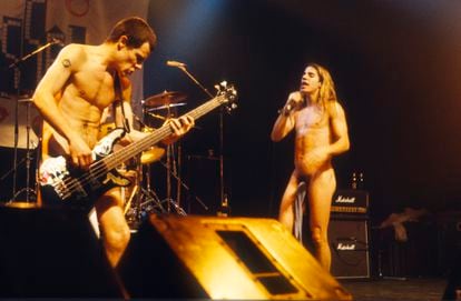 Flea (l) and Anthony Kiedis playing naked, except for strategically placed socks, at a 1985 concert.
