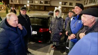 In this photo taken from video released by Russian TV Pool on Sunday, March 19, 2023, Russian President Vladimir Putin talks with local residents during his visit to Mariupol in Russian-controlled Donetsk region, Ukraine.