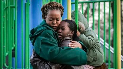 Derry Oliver, 17, right, hugs her mother, also Derry Oliver, during a visit to a playground near home, Friday, Feb. 9, 2024, in New York.