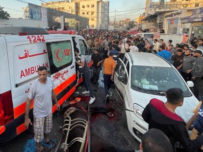 Palestinians check the damages after a convoy of ambulances was hit, at the entrance of Shifa hospital in Gaza City, November 3, 2023.