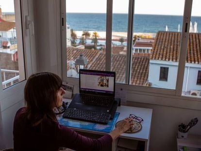 A woman works remotely from home during the coronavirus lockdown in Spain.