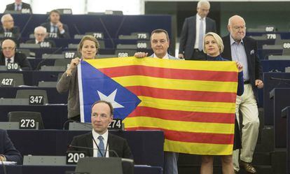 Members of the European Parliament pose with a Catalan secessionist flag during the debate