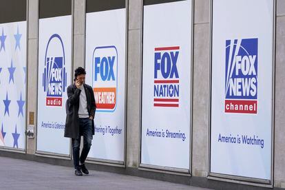 FILE - A man walks past the News Corp. Building and Fox News Headquarters,April 19, 2023, in New York.