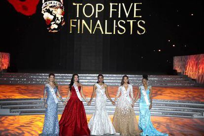 The top five finalists hold hands before the winner is announced.